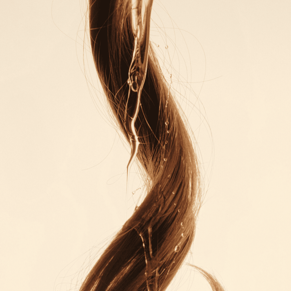 a strand of hair with oil dripping