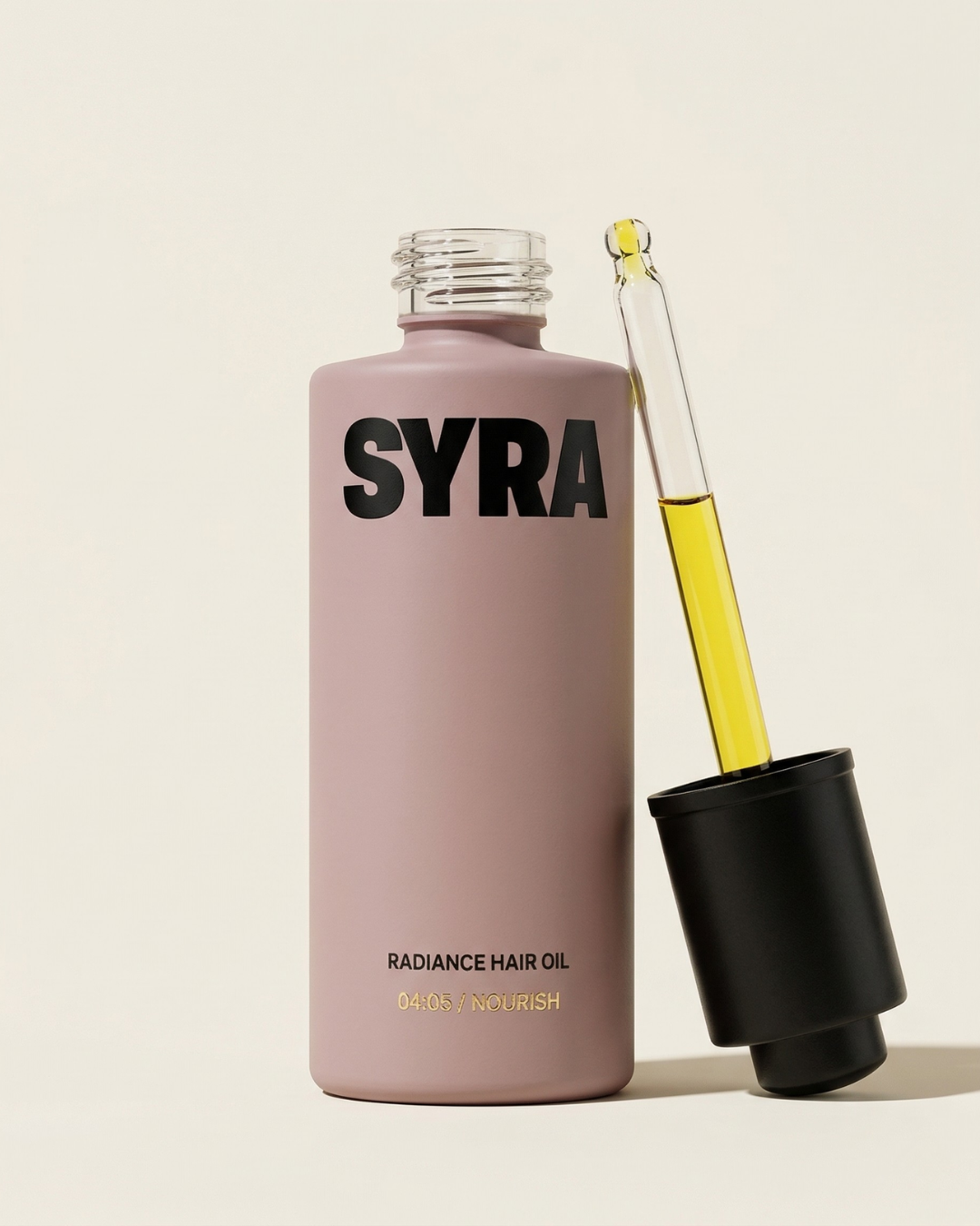 SYRA radiance hair oil bottle with dropper on a light background