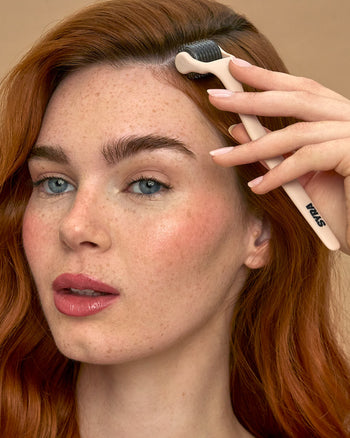 Woman using Syra glow 0.5mm stainless individual needle derma roller on the scalp 