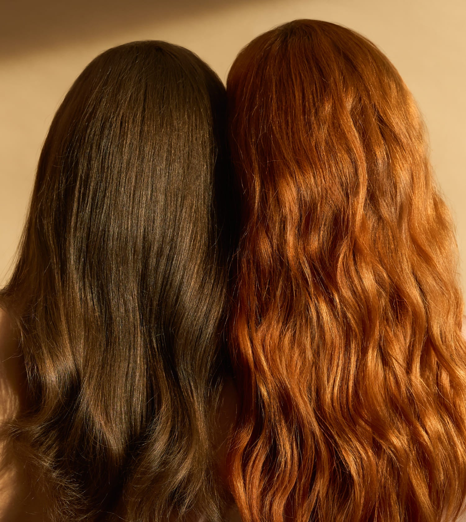 Two girls heads, one brown and one red, displayed side by side against a neutral background.