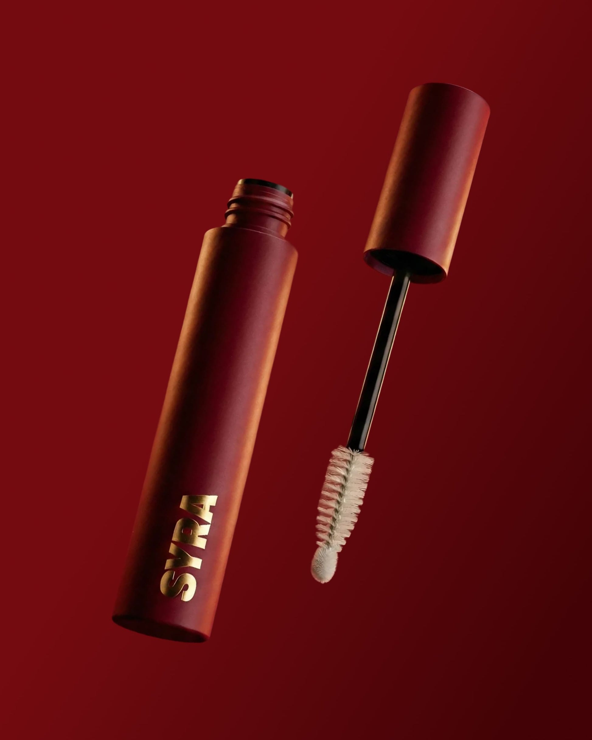 Brow oil with spoolie on a red background
