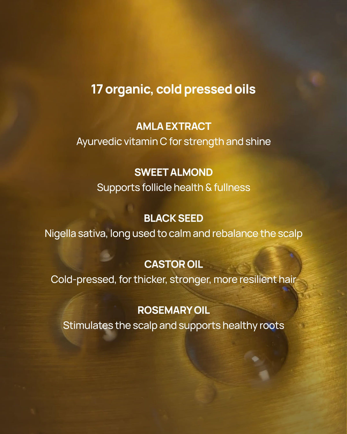 A close-up of a golden liquid surface with water droplets and white text listing ingredients: 17 organic, cold pressed oils, including Amla Extract, Sweet Almond, Black Seed, Castor Oil, and Rosemary Oil.
